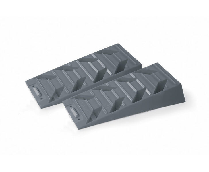 two gray plastic ramps for leveling or stabilizing equipment